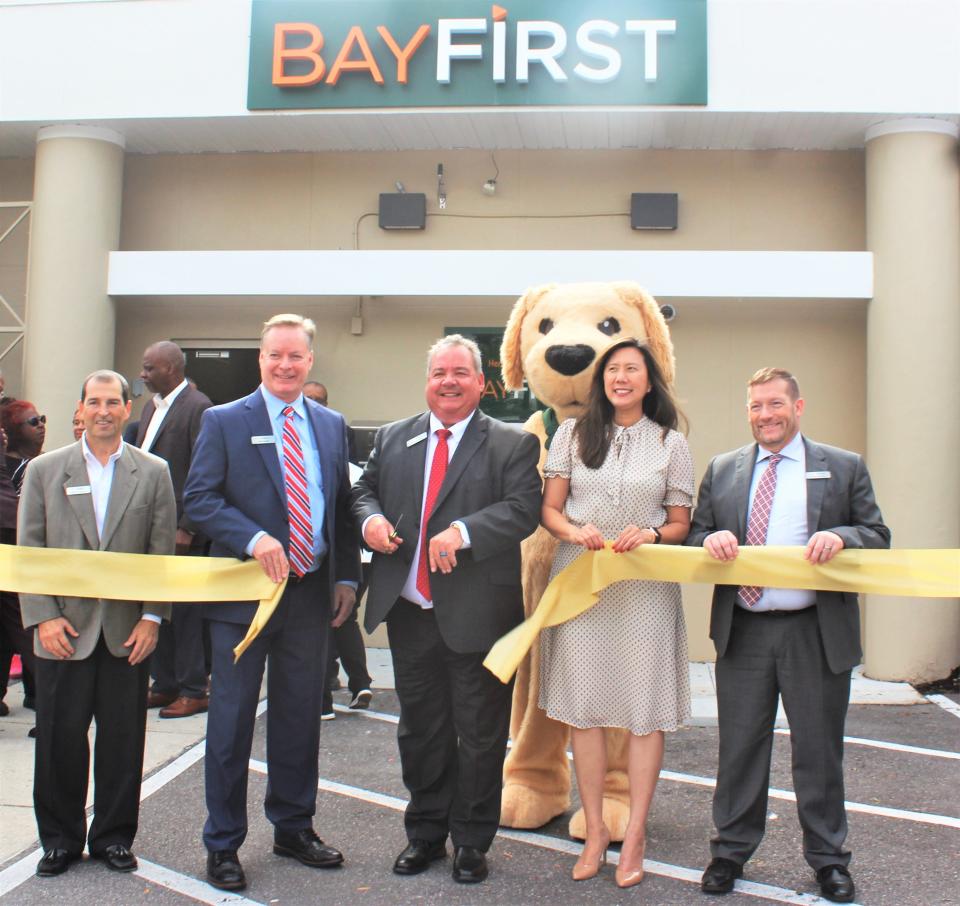 BayFirst National Bank team members, including BayFirst BayFirst executive vice president & chief lending officer Tom Quale, along with Newtown community leaders and residents,celebrate the opening and expansion of the Newtown BayFirst branch.