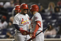 St. Louis Cardinals' Yadier Molina, left, is greeted by Austin Dean (0) after he scored on a triple by Dylan Carlson during the seventh inning of the team's baseball game against the Washington Nationals, Tuesday, April 20, 2021, in Washington. (AP Photo/Nick Wass)