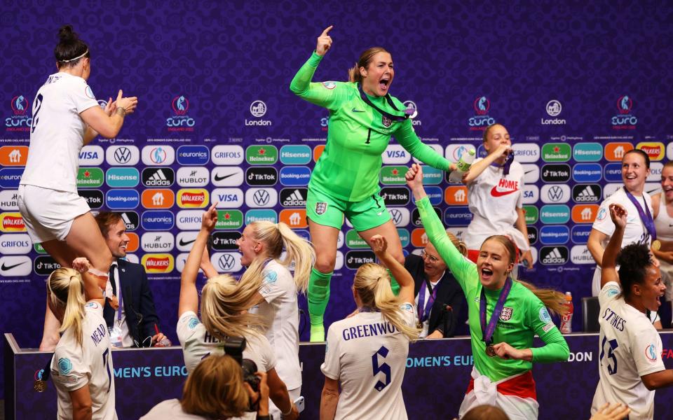 Lucy Bronze and Mary Earps dance on the press conference table after interrupting matters - GETTY IMAGES