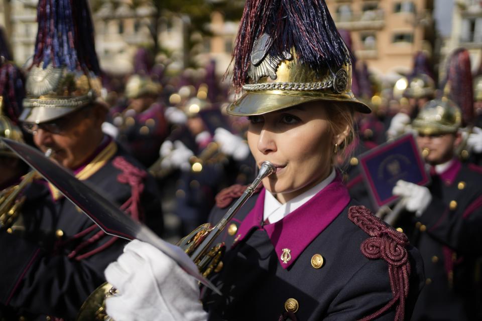 A member of a philharmonic band performs during the procession of Jesus' funeral bier, called the "Epitaph" in Greek, during Easter celebrations on the Ionian Sea island of Corfu, northwestern Greece, on Saturday, April 23, 2022. For the first time in three years, Greeks were able to celebrate Easter without the restrictions made necessary by the coronavirus pandemic. (AP Photo/Thanassis Stavrakis)