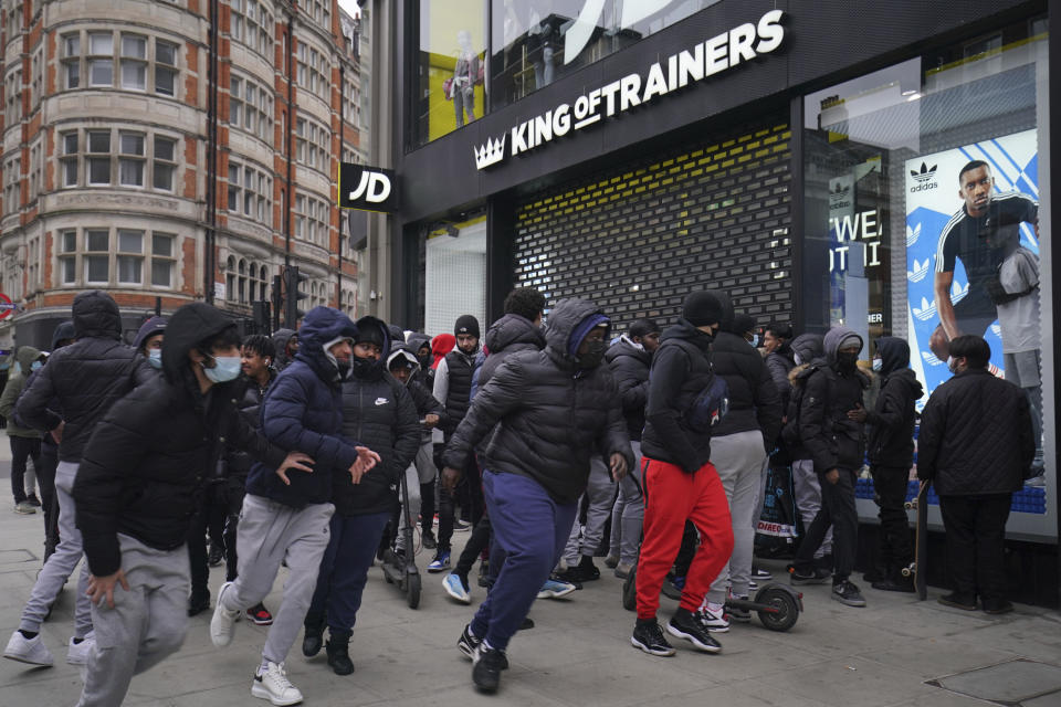 Early morning shoppers in Oxford Street, London, Monday April 12, 2021. Millions of people in Britain will get their first chance in months for haircuts, casual shopping and restaurant meals on Monday, as the government takes the next step on its lockdown-lifting road map. (Aaron Chown/PA via AP)