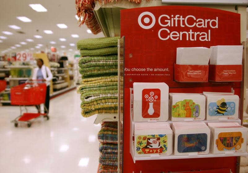 A lone shopper makes her way down an aisle behind a shopping cart past a display for gift cards in the Super Target in the east Denver suburb of Glendale, Colo., on Tuesday, May 16, 2006. Target announced its quarterly earnings on Tuesday. (AP Photo/David Zalubowski)