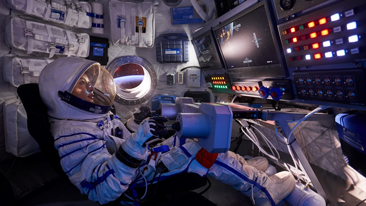  An guest dressed as an astronaut flies a space shuttle in an immersive sci-fi experience. . 