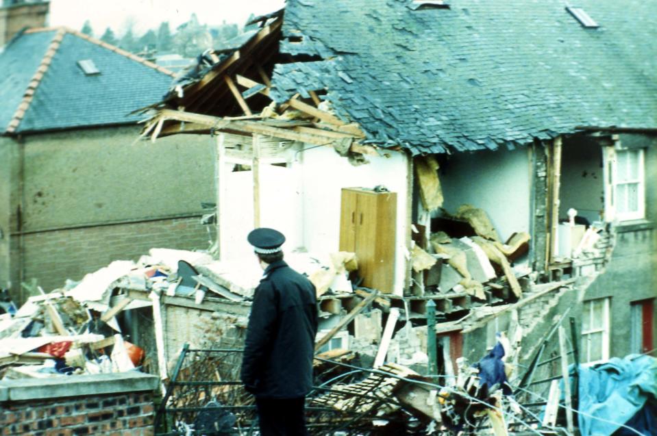 A police officer walks past the damage in Lockerbie, Scotland, caused by Pan Am Flight 103 from London to New York in December 2008.