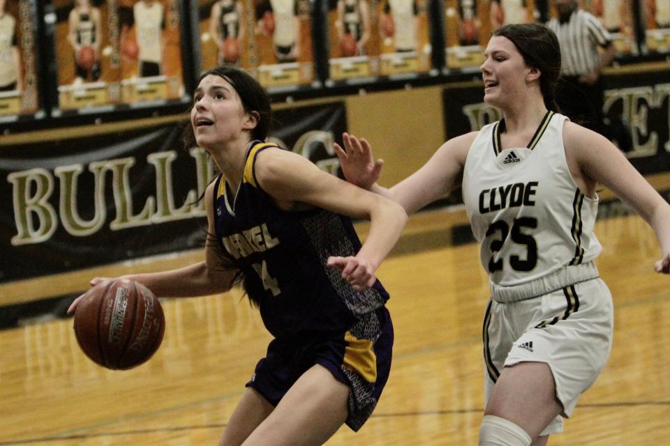 Merkel senior Alyssa O'Malley picks up her dribble while guarded by Clyde's Morgan Mauldin.