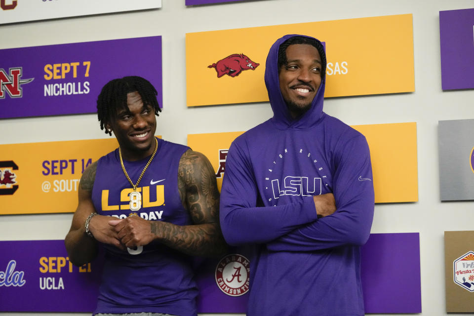 LSU quarterback Jayden Daniels, right, and wide receiver Malik Nabers wait for their turn to speak at the podium for player interviews during LSU's NCAA football pro day in Baton Rouge, La., Wednesday, March 27, 2024. (AP Photo/Gerald Herbert)