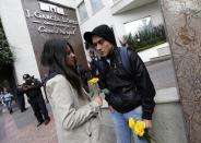 A couple hold yellow roses outside a funeral home after the hearse that left the home of Colombian Nobel Prize laureate Gabriel Garcia Marquez arrived here, in Mexico City April 17, 2014. Garcia Marquez, the Colombian author whose beguiling stories of love and longing brought Latin America to life for millions of readers and put magical realism on the literary map, died on Thursday. He was 87. Garcia Marquez died at his home in Mexico City, a source close to his family said. Known affectionately to friends and fans as "Gabo", Garcia Marquez was Latin America's best-known author and most beloved author and his books have sold in the tens of millions.