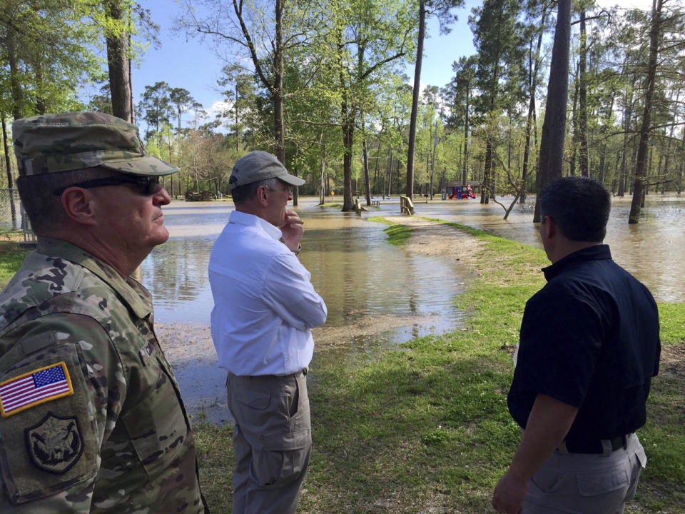 FILE - In this March 13, 2016, file photo provided by Louisiana State Police, Louisiana Gov. John Bel Edwards surveys floods in Vinton, La. At least half a dozen U.S. governors, all Democrats, are heading to the U.N. climate conference in Glasgow, Scotland, to tout their state's climate progress at a critical moment in the United States' efforts to ramp down carbon emissions. (Col. Mike Edmonson/Louisiana State Police via AP, File)