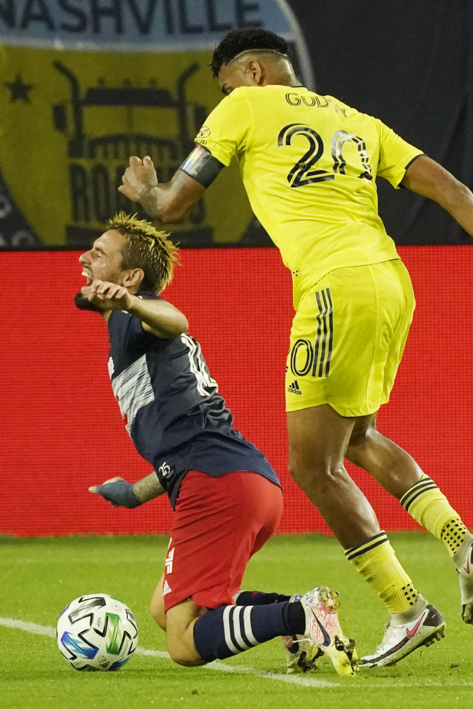 New England Revolution forward Diego Fagundez, left, and Nashville SC midfielder Anibal Godoy (20) collide during the first half of an MLS soccer match Friday, Oct. 23, 2020, in Nashville, Tenn. (AP Photo/Mark Humphrey)