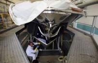 An employee works on a yacht at the Ferretti's shipyard in Sarnico, northern Italy, April 7, 2015. Picture taken on April 7, 2015. REUTERS/Stefano Rellandini