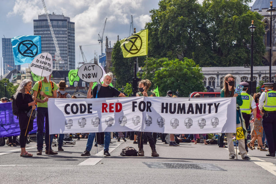  Demonstrators hold a banner which says Code Red For Humanity outside HM Revenue & Customs in Westminster during the protest.
Extinction Rebellion staged protests at several locations in the capital on the second full day of their two-week campaign, Impossible Rebellion, calling on the UK Government to act meaningfully on the climate and ecological crisis. (Photo by Vuk Valcic / SOPA Images/Sipa USA) 