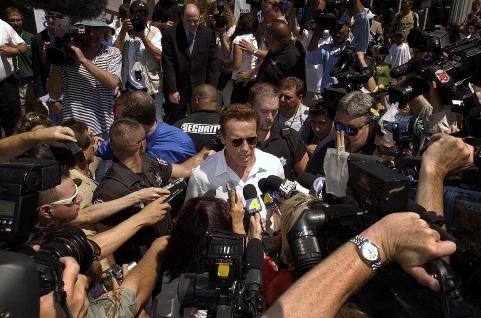 Arnold Schwarzenegger is swarmed by the media during the opening ceremonies of the Inner-City games on Friday, August 8, 2003, a day after he took out papers to run for California governor in the recall election.