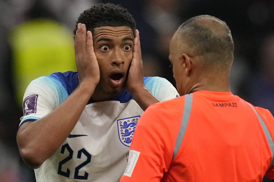 England's Jude Bellingham reacts in front of referee Wilton Sampaio during the World Cup quarterfinal soccer match between England and France, at the Al Bayt Stadium in Al Khor, Qatar, Saturday, Dec. 10, 2022. (AP Photo/Frank Augstein)