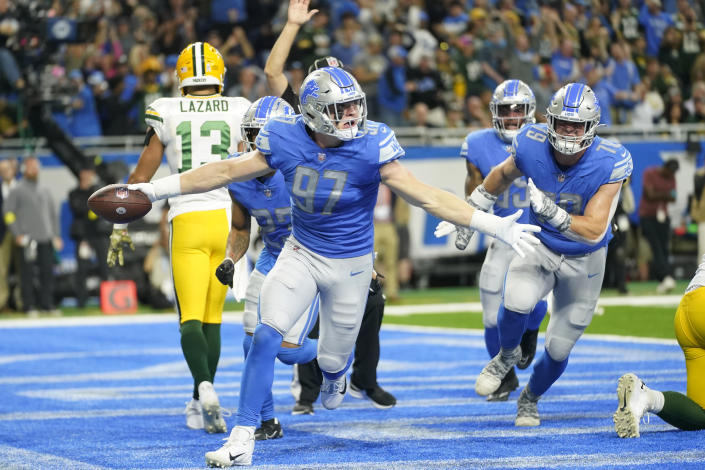 Detroit Lions defensive end Aidan Hutchinson (97) reacts after intercepting a pass intended for Green Bay Packers wide receiver Allen Lazard (13) during the first half of an NFL football game, Sunday, Nov. 6, 2022, in Detroit. (AP Photo/Paul Sancya)
