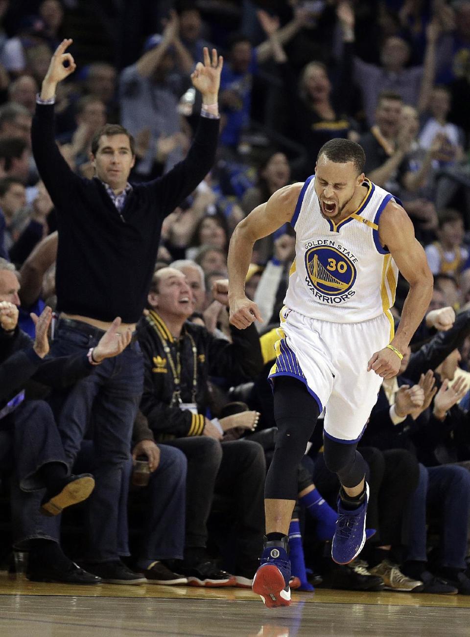 Golden State Warriors' Stephen Curry celebrates a score against the Cleveland Cavaliers during the first half of an NBA basketball game Monday, Jan. 16, 2017, in Oakland, Calif. (AP Photo/Ben Margot)