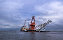 Tugboats get into position on the Russian pipe-laying vessel "Fortuna" in the port of Wismar, Germany, Thursday, Jan 14, 2021. The special vessel is being used for construction work on the German-Russian Nord Stream 2 gas pipeline in the Baltic Sea. ( Jens Buettner/dpa via AP)