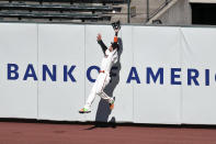 San Francisco Giants' Wilmer Flores makes a leaping catch at the wall on a ball hit by Colorado Rockies' Charlie Blackmon during the fifth inning of a baseball game in San Francisco, Thursday, Sept. 24, 2020. (AP Photo/Jed Jacobsohn)