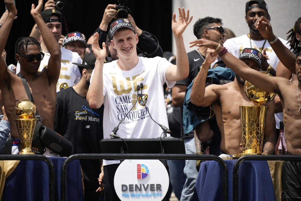 Denver Nuggets center Nikola Jokic celebrates during a rally and parade to mark the team's first NBA basketball championship on Thursday, June 15, 2023, in Denver. (AP Photo/David Zalubowski)