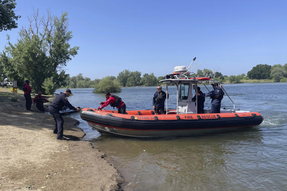 Swift water rescue teams conduct an exercise on the American River in Sacramento, Calif., Tuesday, May 23, 2023. California rivers fed by winter's massive Sierra Nevada snowpack have been turned into deadly torrents, drawing warnings from public safety officials ahead of the Memorial Day weekend and the traditional start of outdoor summer recreation. (AP Photo/Haven Daley)