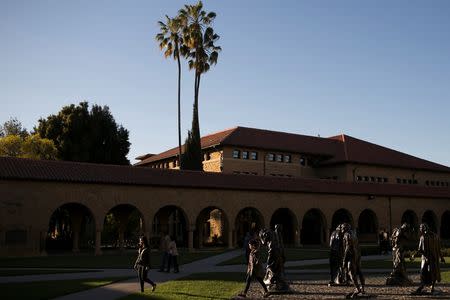 Pedestrians walk past a group of statues at Stanford University in Stanford, California March 11, 2014. REUTERS/Stephen Lam