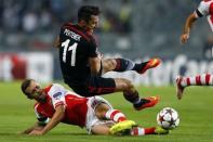 Besiktas' Mustafa Pektemek fights for the ball with Arsenal's Jack Wilshere (L) during the first leg of their Champions League qualifying soccer match at Ataturk Olympic stadium in Istanbul August 19, 2014. REUTERS/Murad Sezer