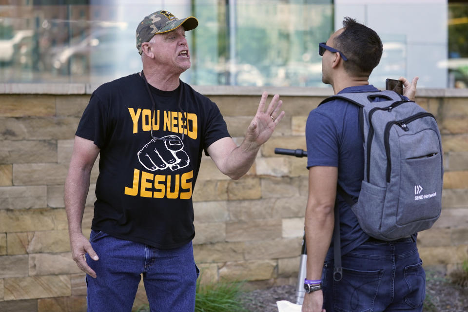 A man, who identified himself as J. K. of Atlanta, left, argues a point outside the annual Southern Baptist Convention meeting Monday, June 14, 2021, in Nashville, Tenn. A number of people demonstrated against the denomination's practices outside the venue. (AP Photo/Mark Humphrey)