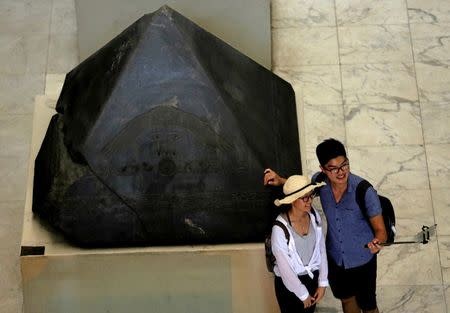 Chinese tourists take a selfie picture around pharaonic artifacts inside the Egyptian Museum in Cairo, Egypt June 23, 2016. REUTERS/Amr Abdallah Dalsh