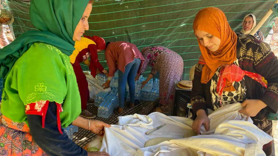 Leila Idabdelah (R) makes bread for her neighbors in a tent near her destroyed village on Sunday, September 10. - Ivana Kottasová/CNN