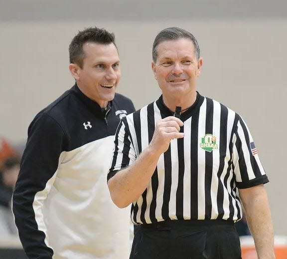 Referee Carl Davidson listens to Carrollton head coach Mike Aukerman as he works the Warriors game against New Lexington during the Mercy Medical Classic at Hoover High School on Feb. 17, 2019.
