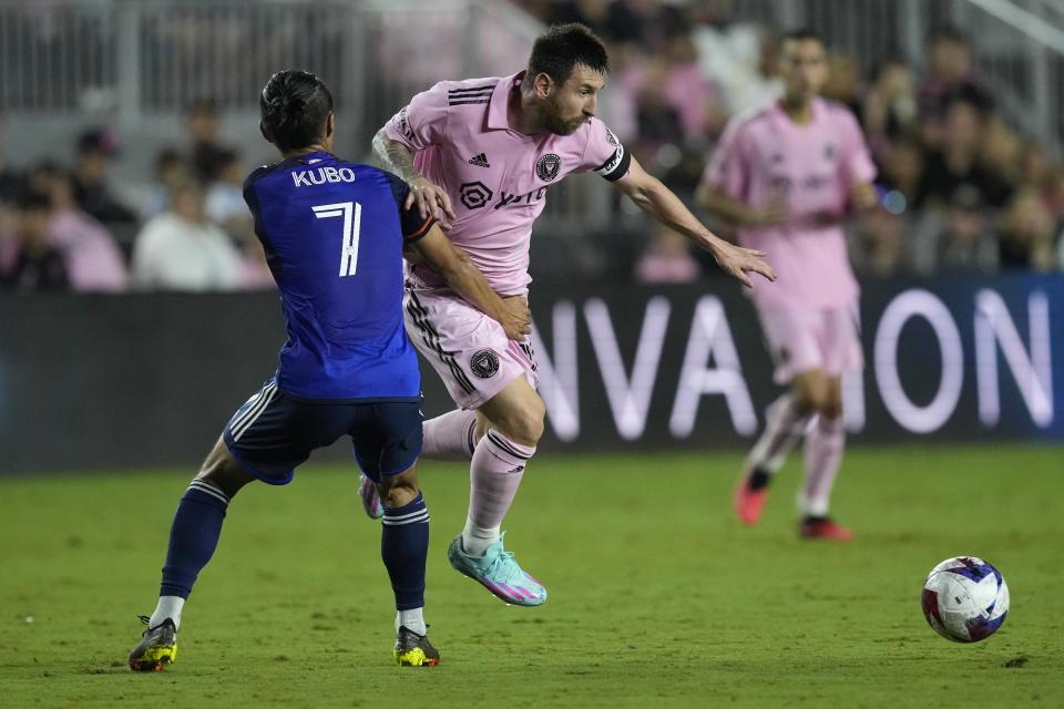 Inter Miami forward Lionel Messi, front right, fights to get past FC Cincinnati forward Yuya Kubo (7) during the second half of an MLS soccer match, Saturday, Oct. 7, 2023, in Fort Lauderdale, Fla. (AP Photo/Rebecca Blackwell)