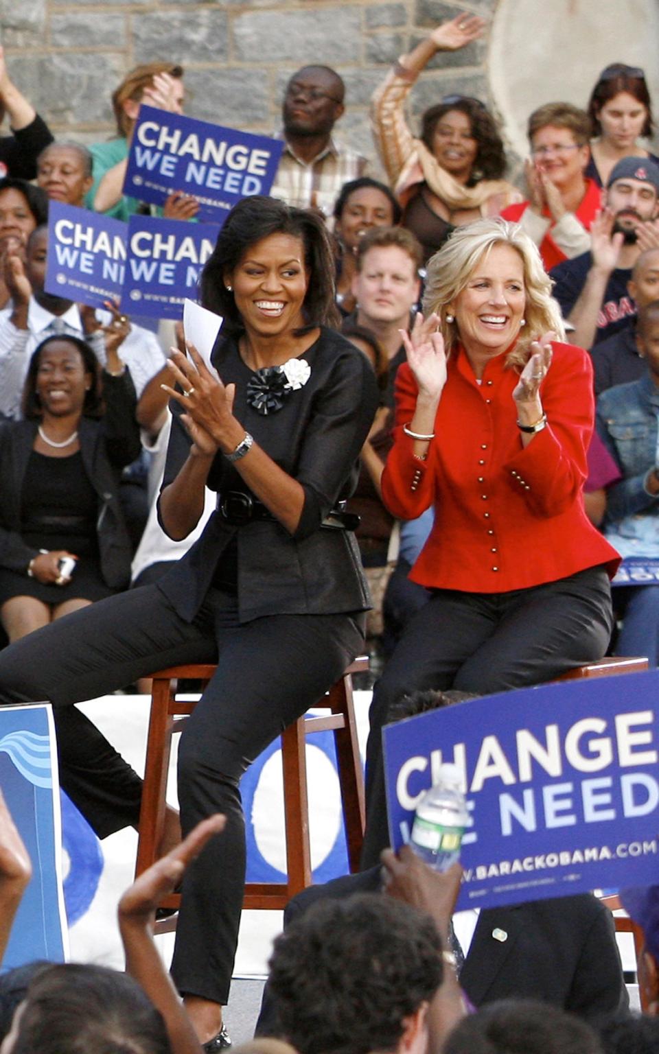 Michelle Obama and Jill Biden applaud during a rally for their husbands on the Democratic presidential ticket in 2008