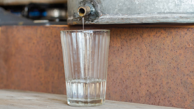 Illicit alcohol pouring into cup