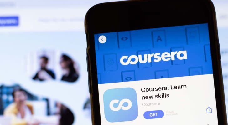 The app page for Coursera is displayed on a smartphone screen with a website in the background.