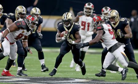 Nov 5, 2017; New Orleans, LA, USA; New Orleans Saints running back Alvin Kamara (41) runs with Tampa Bay Buccaneers defensive tackle Gerald McCoy (93) and outside linebacker Lavonte David (54) defending in the second half at the Mercedes-Benz Superdome. The Saints won, 30-10. Chuck Cook-USA TODAY Sports