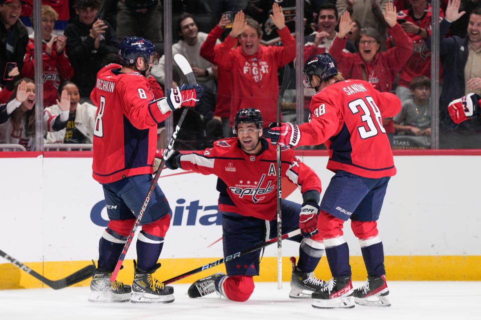 Washington Capitals right wing Tom Wilson, center, celebrates his goal against the Columbus Blue Jackets with left wing Alex Ovechkin (8) and defenseman Rasmus Sandin (38) during the first period of an NHL hockey game Saturday, Nov. 4, 2023, in Washington. (AP Photo/Jess Rapfogel)