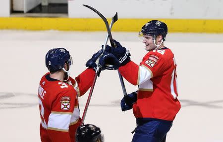 Dec 15, 2018; Sunrise, FL, USA; Florida Panthers center Aleksander Barkov (16) celebrates his game winning goal and hat trick against the Toronto Maple Leafs with Florida Panthers defenseman Keith Yandle (3) in overtime BB&T Center. Mandatory Credit: Robert Mayer-USA TODAY Sports