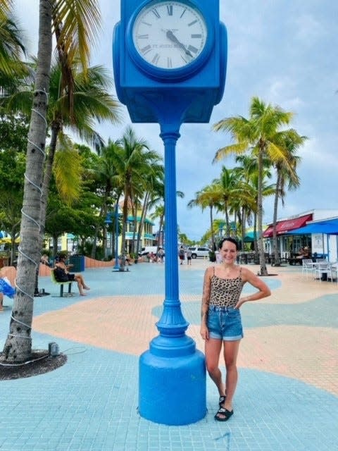 A new Fort Myers Beach clock at Times Square is soon to arrive, city officials said Friday, June 9, 2023.  The original was lost to Hurricane Ian. Marie Pier posted this photo of herself standing next to the clock in Times Square on Fort Myers Beach. It was taken in August 2021. She wrote in the caption "Forever in my heart."