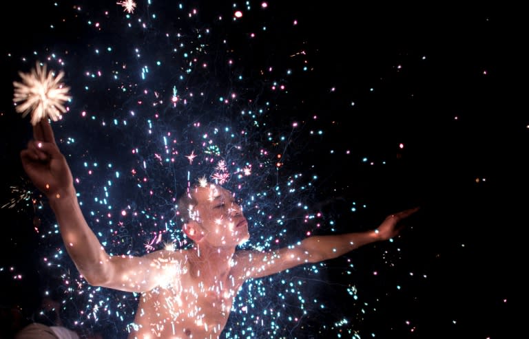 A Fangshan villager performs the 'eating flowers' ritual - bathing in a shower of scorching sparks - to wash away the taint of evil spirits