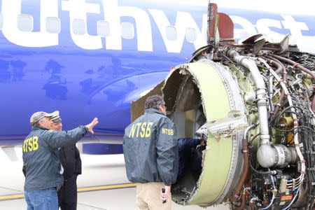 U.S. NTSB investigators are on scene examining damage to the engine of the Southwest Airlines plane in this image released from Philadelphia, Pennsylvania, U.S., April 17, 2018.