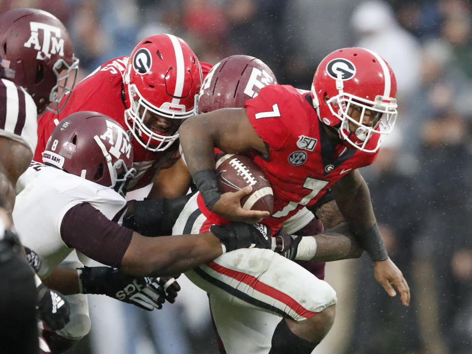 Georgia running back D'Andre Swift (7) struggles for extra yardage against Texas A&M in the first half of an NCAA college football game Saturday, Nov. 23, 2019, in Athens, Ga. (AP Photo/John Bazemore)