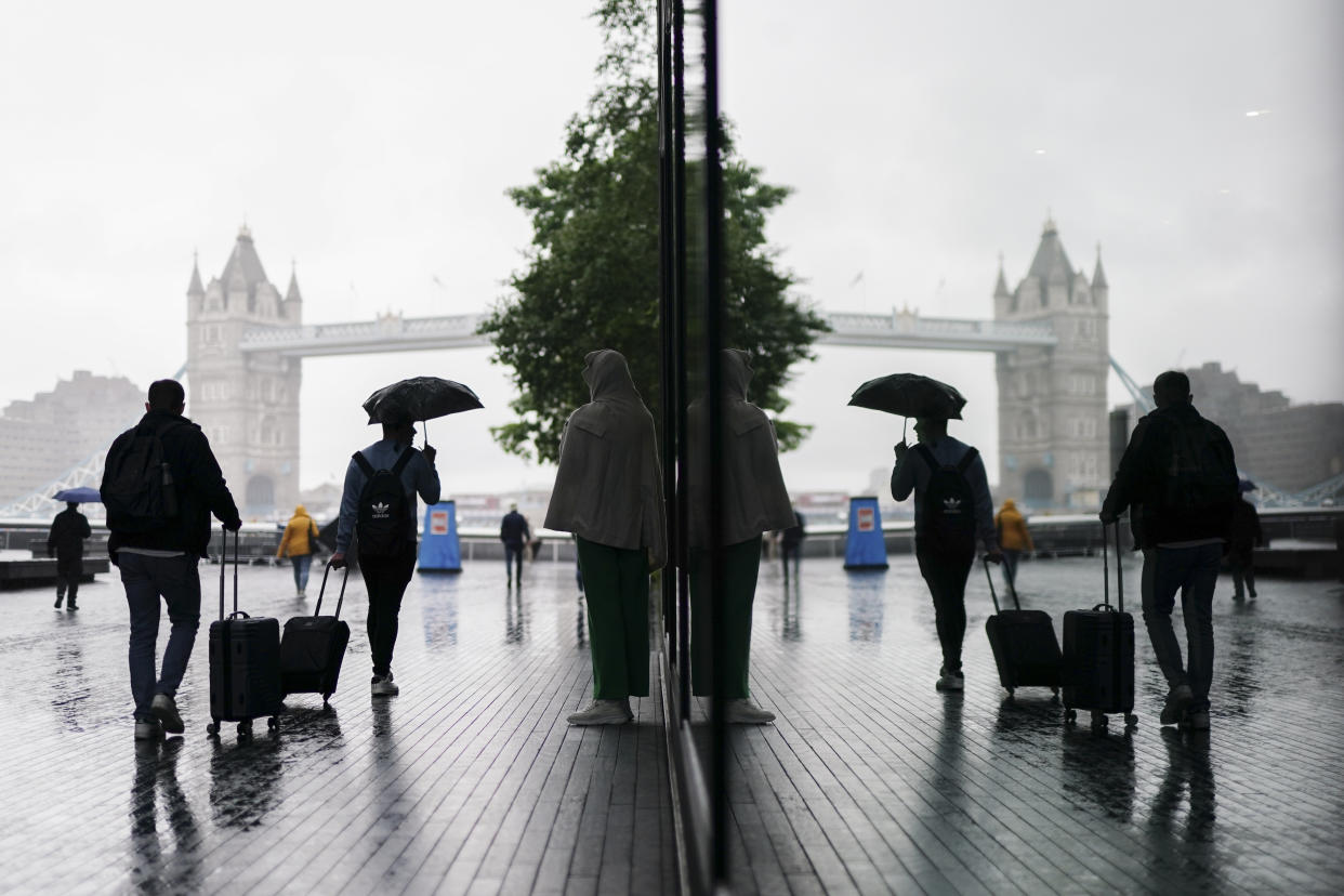 People shelter from the rain beneath umbrellas in Southwark, south London. Picture date: Monday July 24, 2023. (Photo by Jordan Pettitt/PA Images via Getty Images)