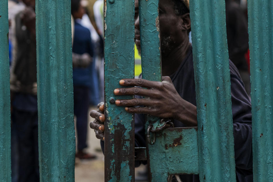 Homeless people stay at the Caledonian stadium downtown Pretoria, South Africa, Thursday April 2, 2020, after being rounded up by police in an effort to enforce a 21 days lockdown to control the spread of the coronavirus. Many of them being addicted, they are receiving methadone syrup from a local NGO, and were complaining about the lack of sanitizer and soap. The new coronavirus causes mild or moderate symptoms for most people, but for some, especially older adults and people with existing health problems, it can cause more severe illness or death.(AP Photo/Jerome Delay)