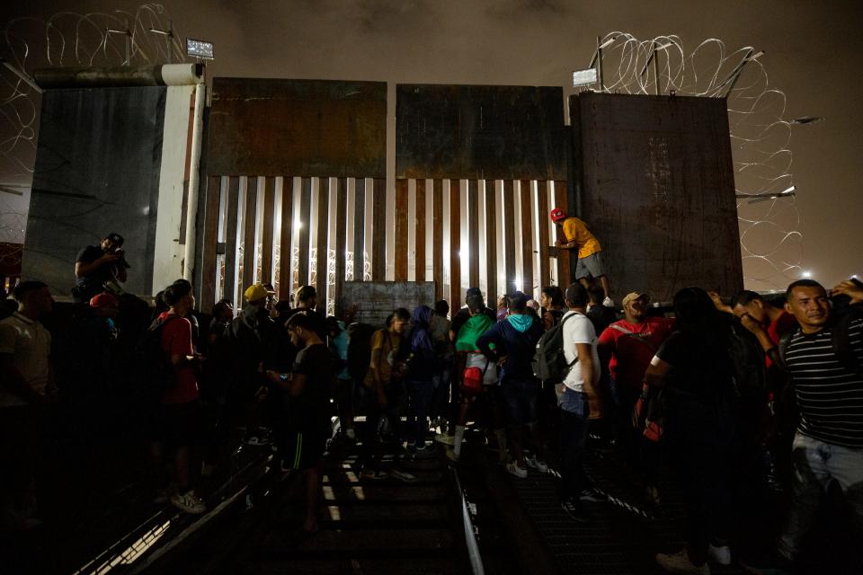 Migrants pleaded with U.S. Customs and Border Protection officers to allow entry into the U.S. as they stood next to a gate on the northbound railroad bridge in Ciudad Juárez that leads into El Paso after a rumor on social media circulated claiming that they would be allowed entry to seek asylum.