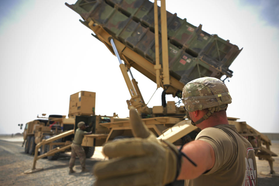 In this photo released by the U.S. Air Force, U.S. Army Spc. Scottlin Bartlett of the 5-52 Air Defense Artillery Battalion signals to a colleague while working near a Patriot missile battery at Al-Dhafra Air Base in Abu Dhabi, United Arab Emirates, May 5, 2021. The wars of the wider Middle East that long surrounded the United Arab Emirates now have encroached into daily life in this U.S.-allied nation, threatening to draw America further into a region inflamed by tensions with Iran. Al-Dhafra has been mentioned as a target by the Iranian-backed Houthi rebels in Yemen who have launched a series of UAE attacks. (Staff Sgt. Jao'Torey Johnson/U.S. Air Force via AP)