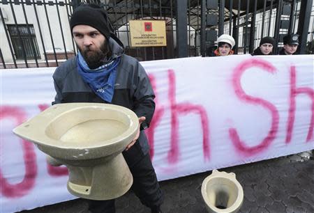 Activists of the "Democratic Alliance" movement stage a performance during a protest rally in front of the Russian embassy in Kiev, February 7, 2014. According to the activists, participants of the protest are reacting to Ukrainian President Viktor Yanukovich's visit to Sochi and his possible meeting with the Russian counterpart Vladimir Putin on February 7, and demanding a stop to the violence in Ukraine. REUTERS/Konstantin Chernichkin