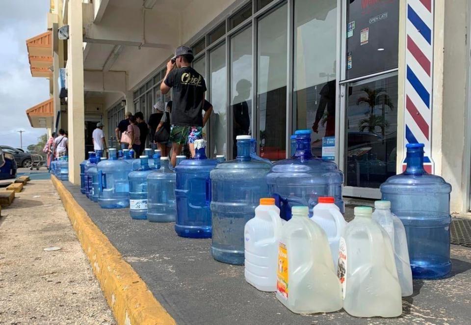 Numerous containers line the sidewalk outside the Wellness Water & Ice store in Yigo, Guam, as island residents make preparations for ahead of Typhoon Mawar (AP)