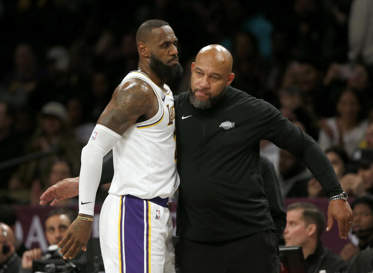 Los Angeles Lakers coach Darvin Ham, right, congratulates forward LeBron James during the second half of the team's NBA basketball game against the Brooklyn Nets on Sunday, March 31, 2024, in New York. (AP Photo/John Munson)