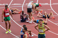 <p>Australia's Edward Trippas (R) reacts with other athletes after competing in the men's 3000m steeplechase heats during the Tokyo 2020 Olympic Games at the Olympic Stadium in Tokyo on July 30, 2021. (Photo by Giuseppe CACACE / AFP)</p> 