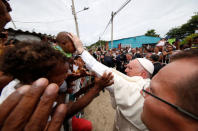 Pope Francis greets a child in a neighbourhood in Cartagena, Colombia September 10, 2017. REUTERS/Stefano Rellandini