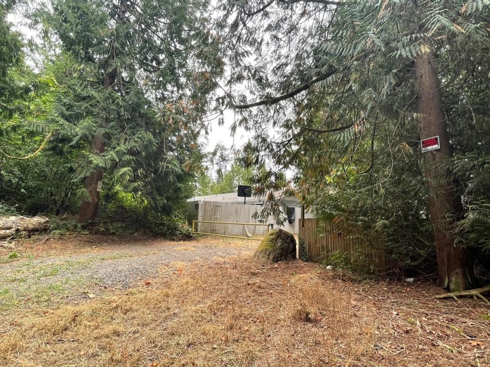 A small path between houses on Ridgetop Court leads into the forested 40-acre parcel behind the Pinewood neighborhood. The property was listed as one of the proposed sites where people would be allowed to camp while there is no overnight shelter available, but strong neighborhood reaction, including a meeting with Mayor Greg Wheeler on Monday, has led the council to postpone a vote on the proposal.